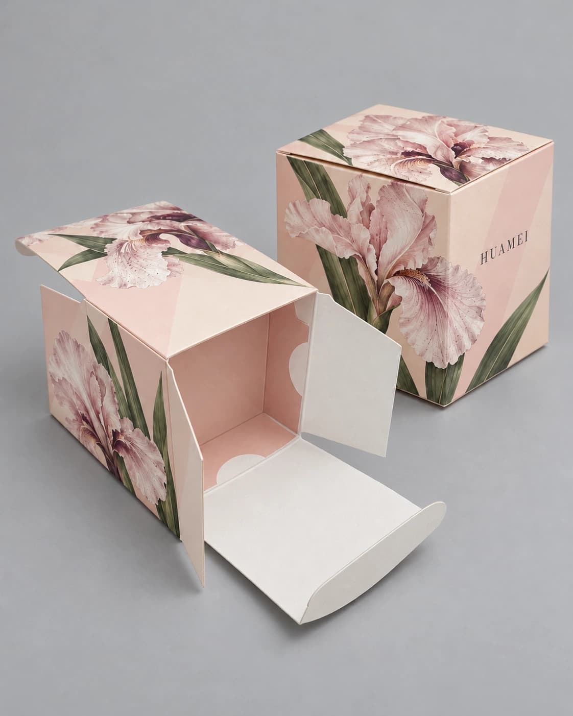 Packaging design illustration of pink iris folding cartons, one open to show its tuck flap and thin paperboard edges