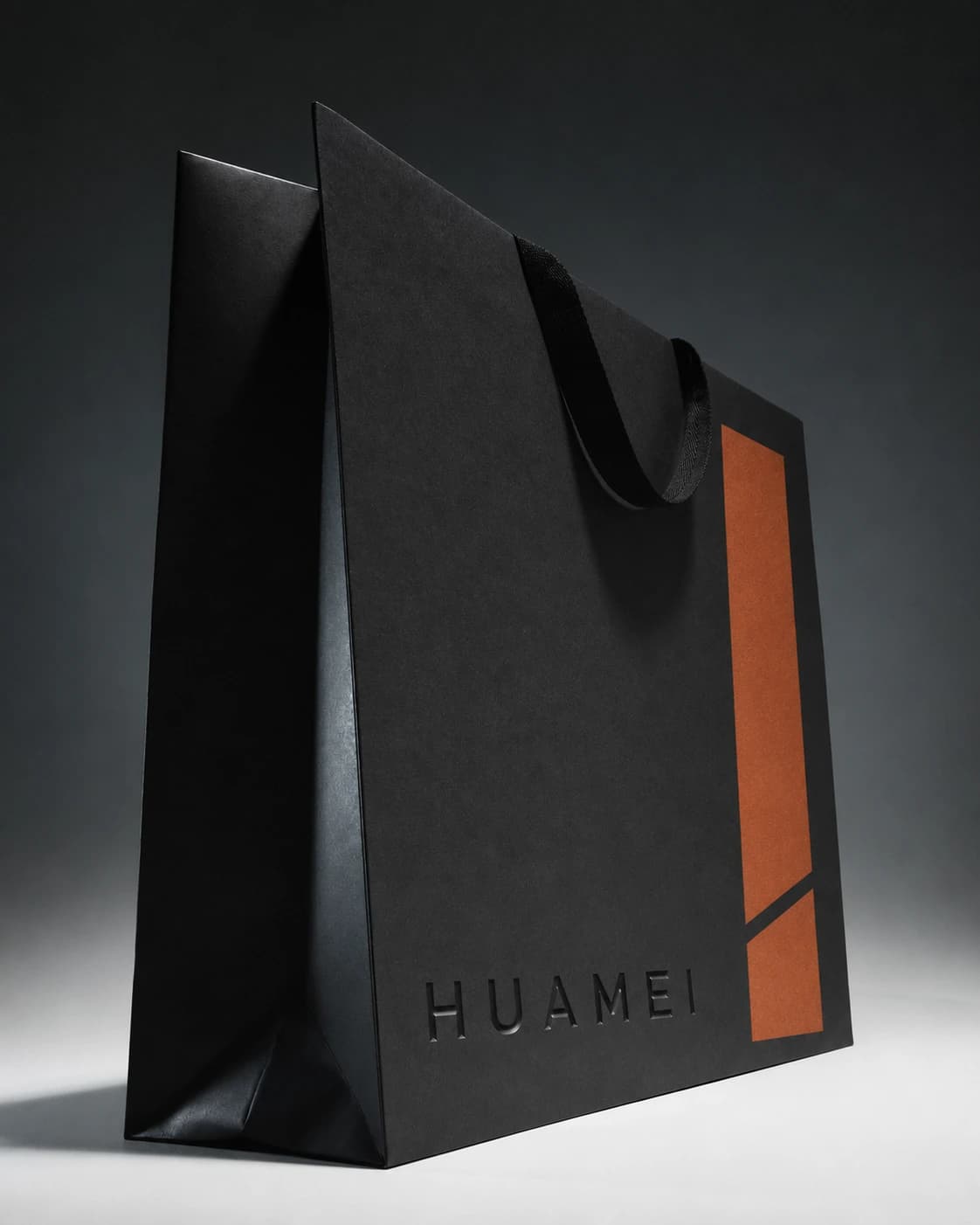 Packaging design illustration of a charcoal paper bag with black fabric handles and terracotta printing