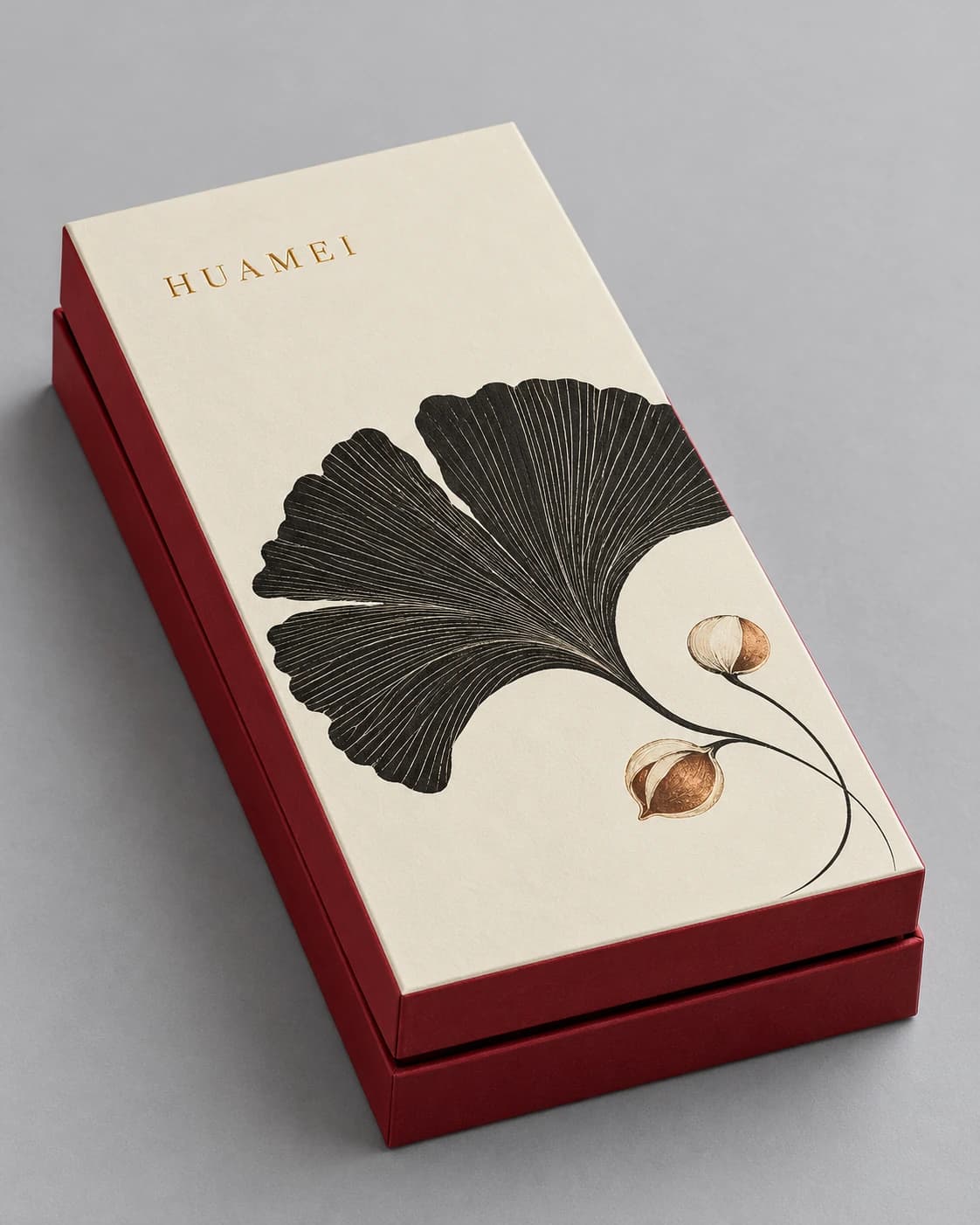 Packaging design illustration of a cream and deep red rectangular rigid gift box with black ginkgo leaf printing and a lift-off lid